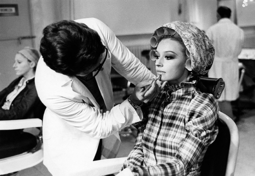 Make-up artist of the TV programme Canzonissima Enzo Amato taking care of the lips of showgirl, singer, presenter & Pop Icon Raffaella Carrà before the TV show begins. Rome, 1970.