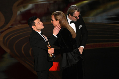Lucy Boynton and Rami Malek, and Roger Taylor of Queen and Sarina Taylor react when Rami receives th