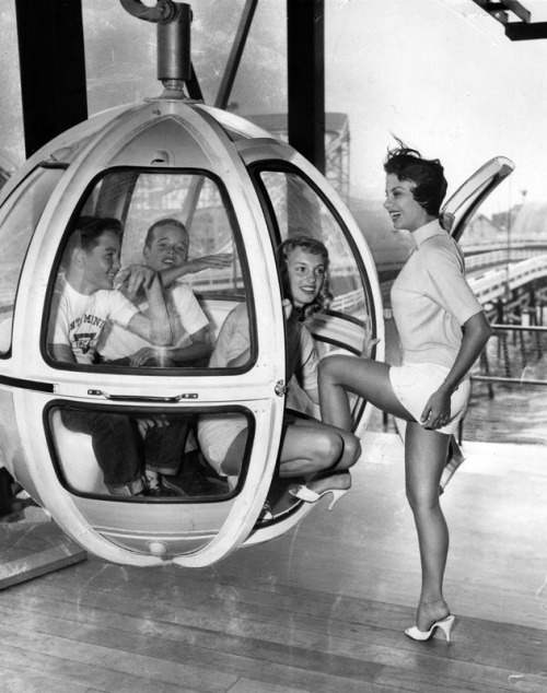 A pair of excited boys join Pacific Ocean Park staff in a Skywayride car, Santa Monica, 1958. POP, which replaced the earlier amusement park at the Ocean Park Pier, closed in 1967. The pier was demolished in 1974 after a series of fires.