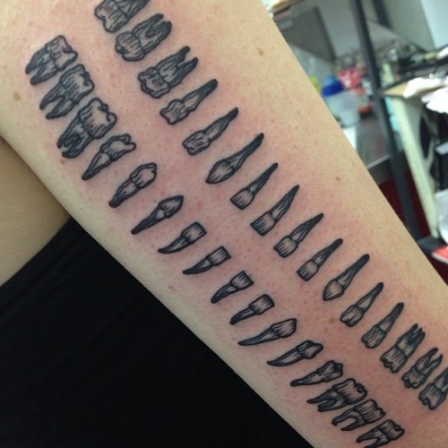 bonesetcetera:Guys I did a thing…. Tattoo of a whole set of teeth on the back of my arm. Done by the