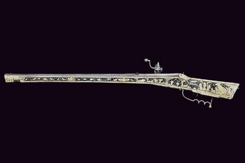 A beautiful 17th century wheel-lock rifle decorated with bone, silver, and gold.  Most likely G