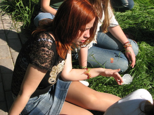 Redhead in sheer pantyhose with short denim skirt in the sun.Woman in pantyhose