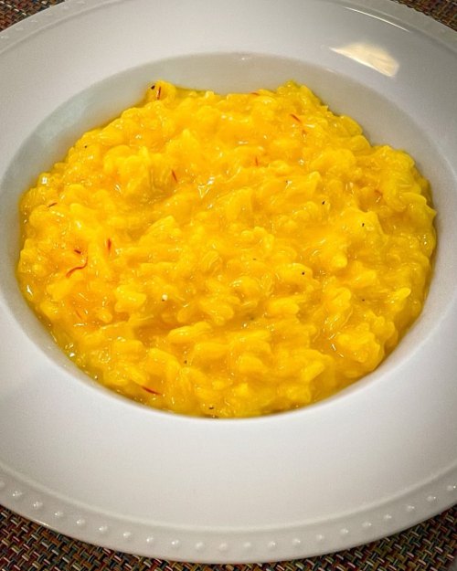 Homemade Saffron Risotto…? Yes, please! #blindgirlblogcooks Photo description: brilliant white bowl with a serving of creamy, golden risotto with crimson threads of saffron at the center of the...