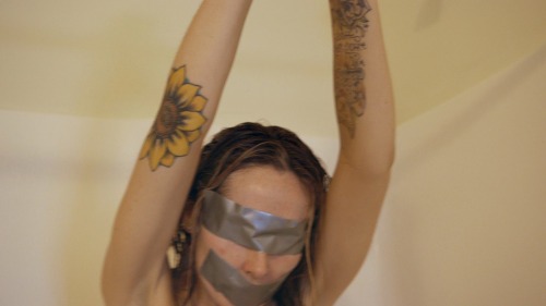 www.seductivestudios.com Daphne is tied arms overhead with duct tape covering her eyes, mouth, belly button, nipples and pussy. She struggles as the water is turned on and she is soaked, left to writhe naked and wet arms overhead… Available at