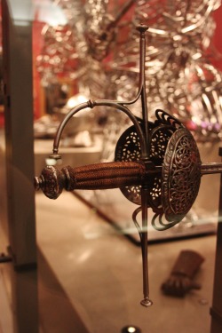 elsegno:  barbucomedie:  Sword hilts on display at the Kelvingrove Museum in Glasgow, Scotland. 1. Cup hilt rapier, early 17th century, Spanish. 2. Swept-hilt rapier, about 1600, English hilt, German blade. 3. Fencing sword, mid-16th century, Italian