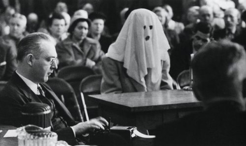 A hooded witness testifies on narcotic trafficking in Washintgon state, April 30th 1952.