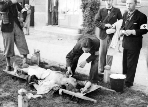 bag-of-dirt:  Polish medics attend to a civilian who was severely injured during the German Luftwaffe’s aerial assault on Warsaw following German invasion of Poland. Warsaw, Masovian Voivodeship, Poland. 1 September 1939.