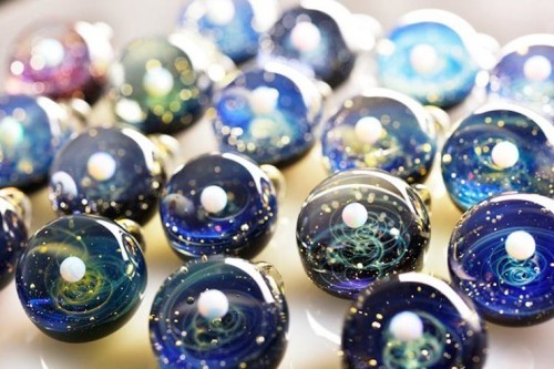 zombies-with-radios:  http://plusalpha-glass.com/index.html  Artist Satoshi Tomizu creates small glass spheres that appear to be miniature solar systems or galaxies, in which planets made of opal are circling into spirals of colored glass and gold flakes.