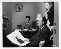 indypendentfilms:  Edith Head, far left, show designs to Alfred Hitchcock and Ingrid Bergman for the 1946 film Notorious.