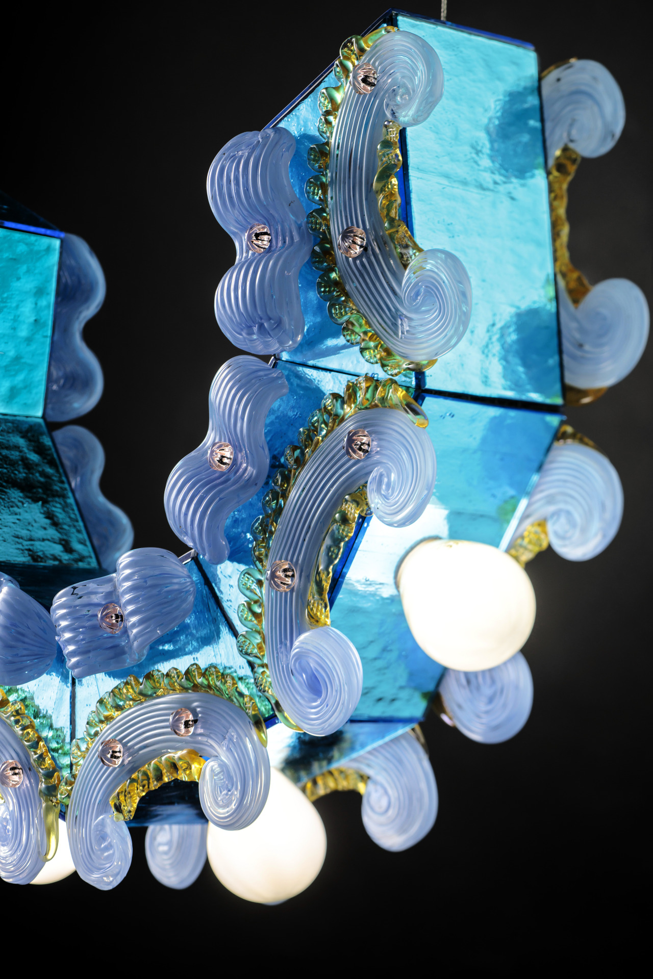 ToppingsA collection of four lamps made of tinted venetian mirrored glass combined with traditional decorative glass curls and pins, which are used as if they were a layer of cream, colored buttercream or thick frosting spread on a base as a garnish....