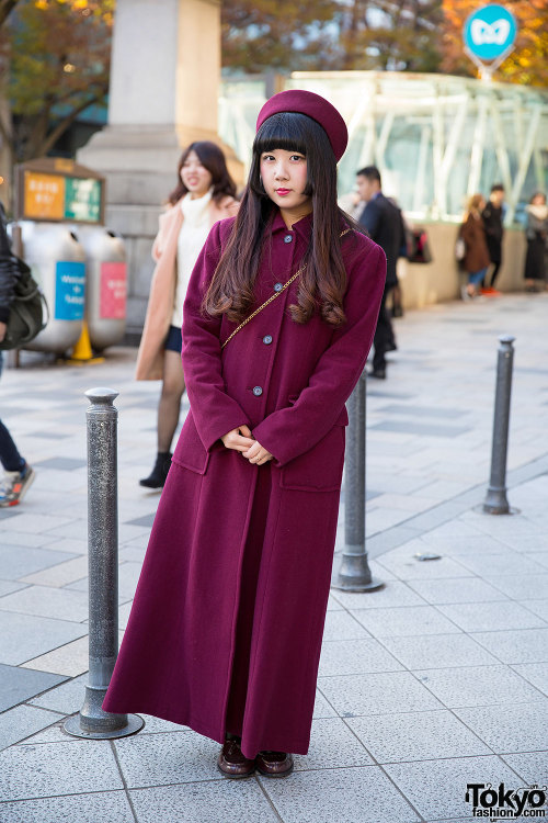 21-year-old Maho on the street in Harajuku wearing a maroon pillbox hat and matching resale maxi-coa