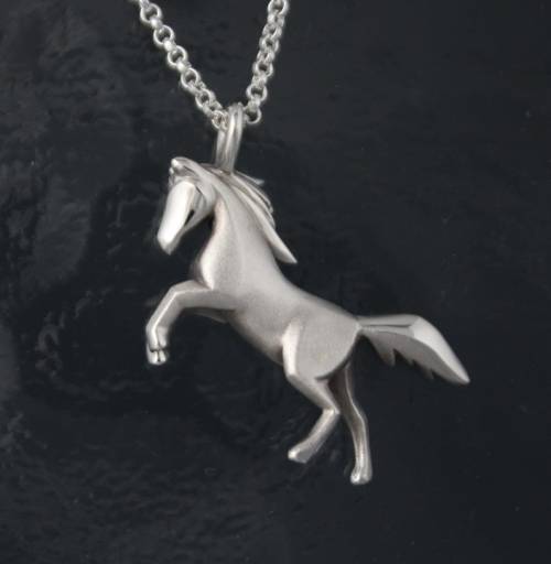 The elegance of horses is captured in this silver pendant by Michael Tatom on Etsy.