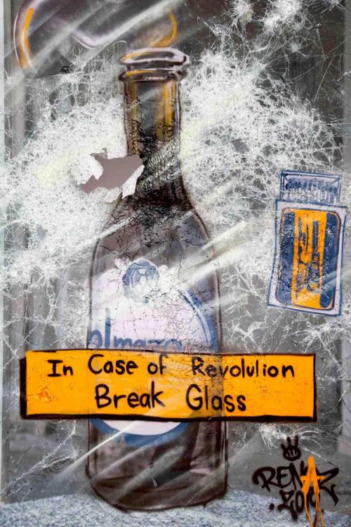 “In case of revolution break glass”Graffiti on the smashed glass facade of a bank in Beirut, Lebanon