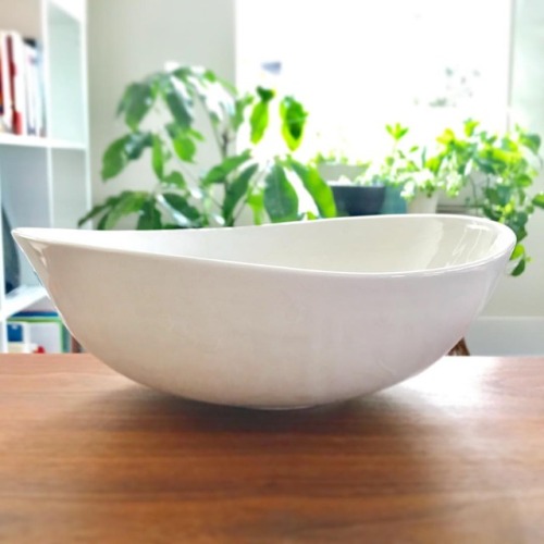 Asymmetrical porcelain serving bowl with an icy white finish. Available in my shop.   #pottery #hand