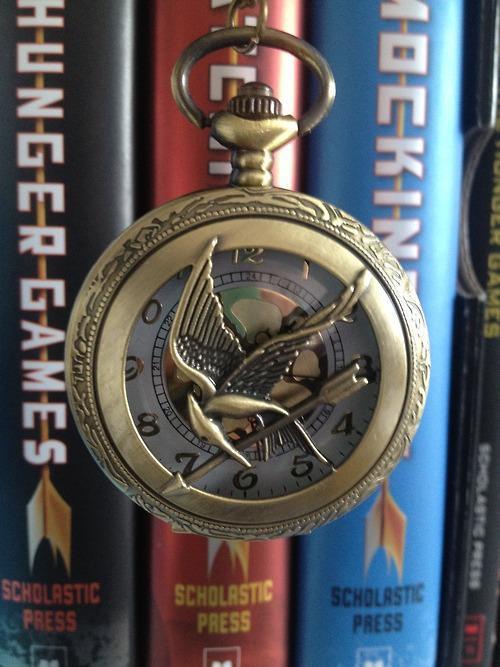 bookswarmmilkandcookies:  Mockingjay Pin Clock the hunger games | Tumblr on We Heart