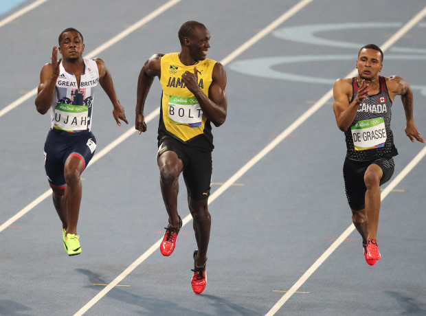 Usain Bolt smiles for the camera as he wins the Olympic 100 metres final.