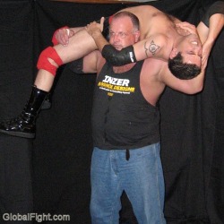 wrestlerswrestlingphotos:  a huge musclebear lifting helpless young wrestler