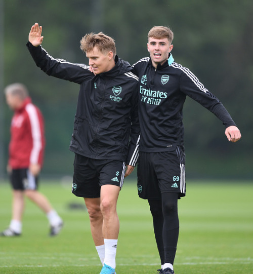 Martin Odegaard with Zak Swanson and Marcelo Flores of Arsenal during a training session at London C