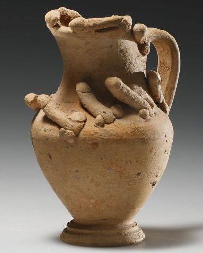 hellenismo:JUG WITH PHALLOI– Shoulder and mouth encircled by separately modelled phalloi. Roman, 1st