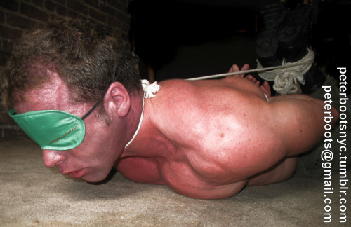 peterbootsnyc:  Noosed hogtie The noose is tightening and his face is taking on a nice shade of red.