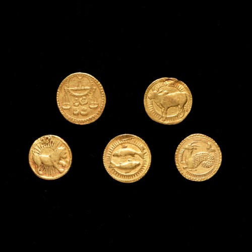 Coins with symbols of the zodiac, an idea the emperor recorded in his journals.    Minted in India d