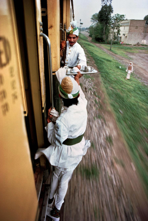 historicaltimes: Breakfast tea being passed between train cars in Peshawar, Pakistan, 1983 via reddi