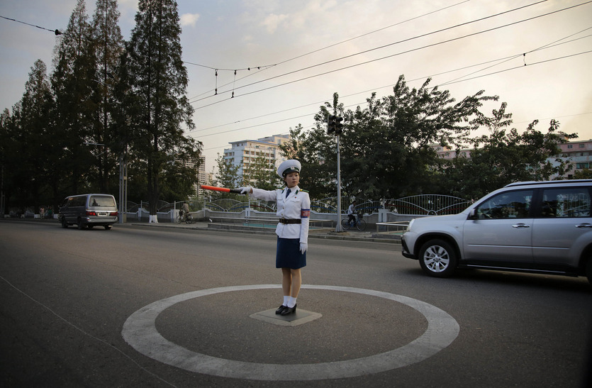 A police woman directed evening traffic in Pyongyang, North Korea (Photo by Wong Maye-E/Associated Press via Lens)