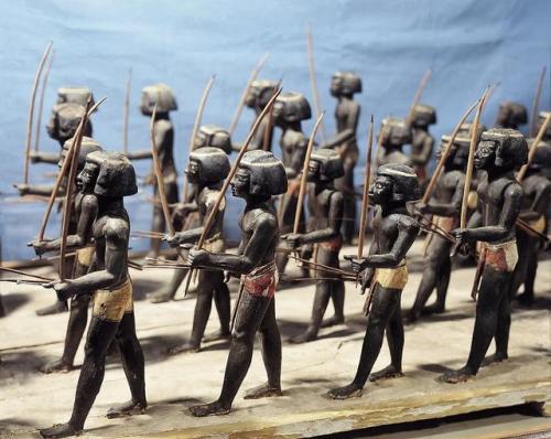 Model of Nubian ArchersThese wooden models of 40 Nubian archers are grouped together on the same ped