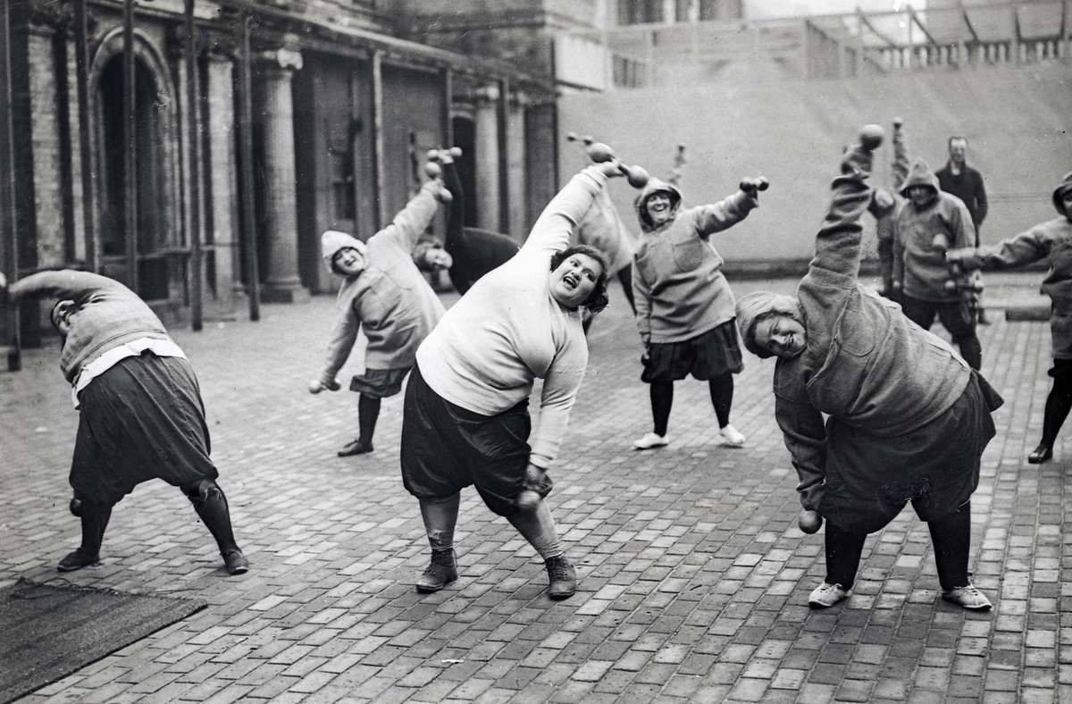 Photographer Unknown
Gymnastics, lose weight. Group fat women undergoing slimming course in a courtyard in New York, 1920s.