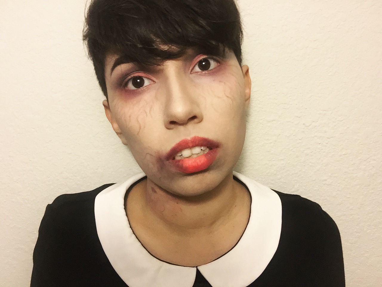 Zombie or Vampire makeup look.  Add some blood, puts some lashes on with vampire