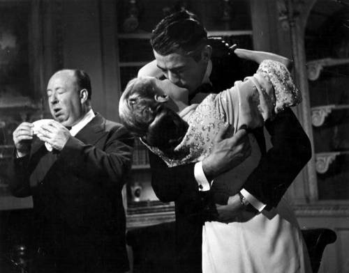 touchingfromadistance137:Alfred Hitchcock sneezing while Ingrid Bergman and Gregory Peck kiss on the
