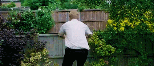 Simon Pegg vaulting over a fence