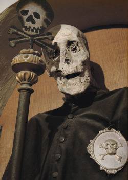 mortem-et-necromantia:Vincenzo Piccini is the only clothed mummy in the Chiesa Dei Morti of the Confraternity of Buona Morte in Urbania, Italy. He is dressed in the robes of the religious order he was a member of and he wears the silver badge of Death.