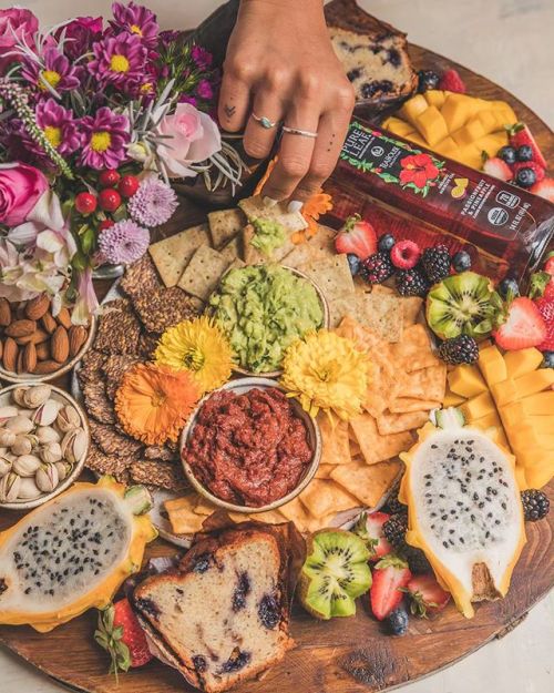 starting mother’s day brunch with beautiful blooms and a vegan snack platter including guacamo