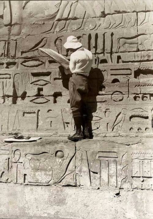 Egyptologist trying to read hieroglyphics in 1927, Karnak Temple, Egypt