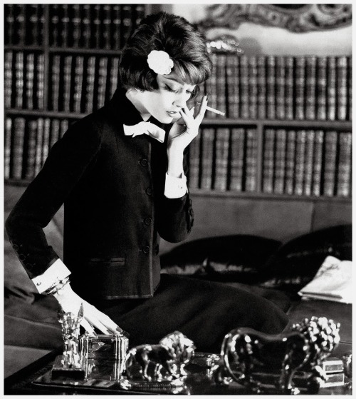 Marie-Hélène Arnaud with books in Coco Chanel’s apartment wearing her black suit accented with white