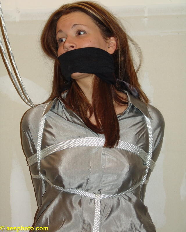 graybandanna:  Tied up in her shiny silver blouse with a black gag 