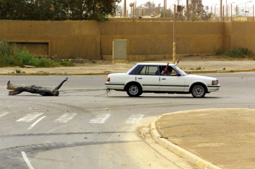 todaysdocument: Using a car, Iraqi civilians drag a statue of Saddam Hussein down the streets of Bag