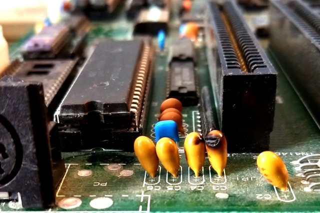 Exploded tantalum capacitors on a PC XT clone motherboard