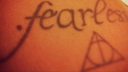 (i submitted the wrong photo oops!)
i got the fearless tattoo first bcus i’m such a big taylor swift fan and i thought the deathly hallows went well with it bcus essentially, when you have all three items, you’re fearless and cannot be beaten. (its...