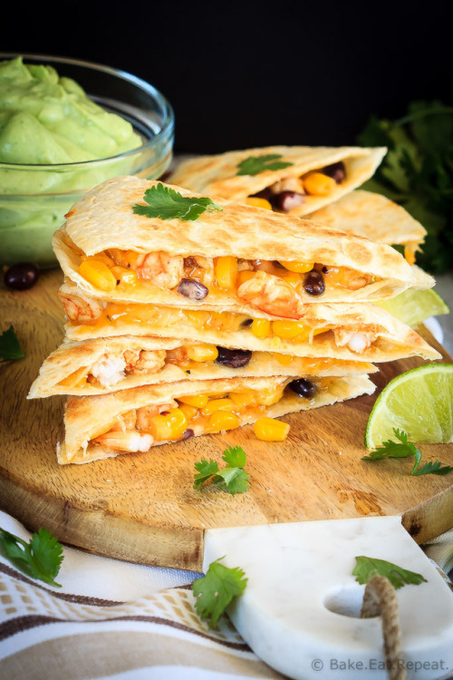 Shrimp quesadillas filled with corn, black beans and cheese, and an avocado cilantro lime cream dipp