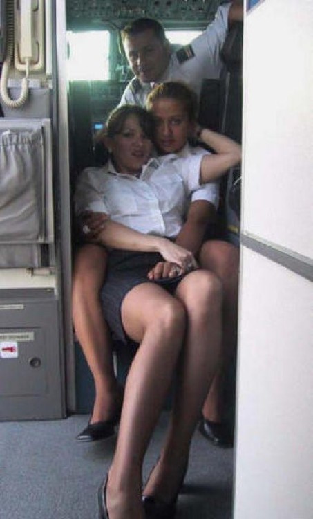 airplanebabes:  Two flight attendants pose at the entrance to the cockpit …