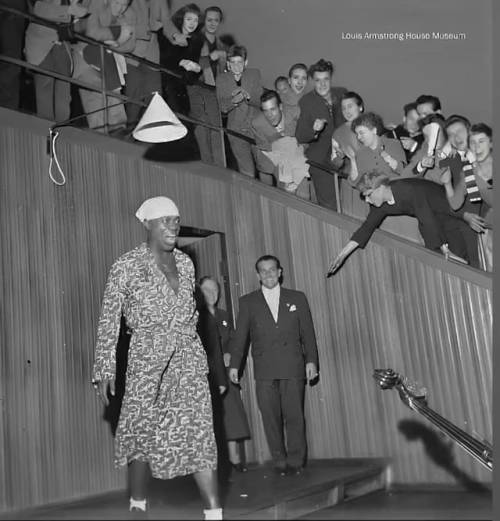 blondebrainpower:  Louis Armstrong after his 1955 concert in Denmark. The crowd wouldn’t let him go, so Louis kept on coming out to take bows until he finally came out one last time in his bath robe. 
