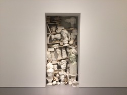 slanting:  Jannis Kounellis, untitled (1980) In the mid 1970s, Jannis Kounellis began creating installations that consist of pieces of statuary stacked in doorways or on tables and shelves to represent a breakdown of cultural coherence. Untitled evokes