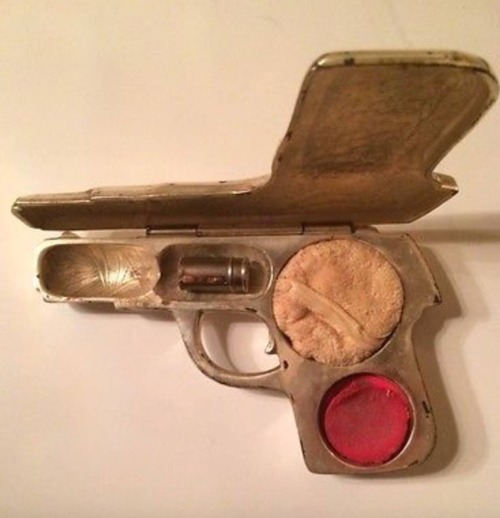 flowerfingers:  Ladies makeup compact fashioned in the shape of a pistol – complete with powder, cheek rouge and lipstick in the shape of a bullet, ca.1920 