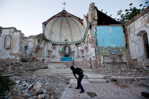 letsbuildahome-fr: Three years later, Haiti honors earthquake victims Picture: Man sweeps an ex