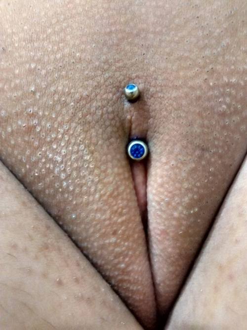 pussymodsgaloreA Christina piercing with a colourful decorative curved barbell.