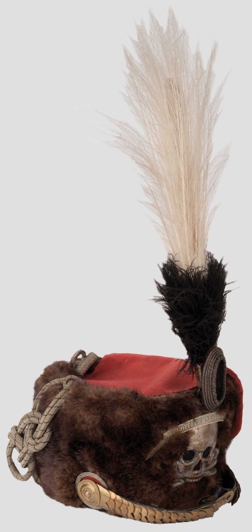 The Hussar’s Busby is, in effect, a shako covered by cloth or fur. These hats reached the heig