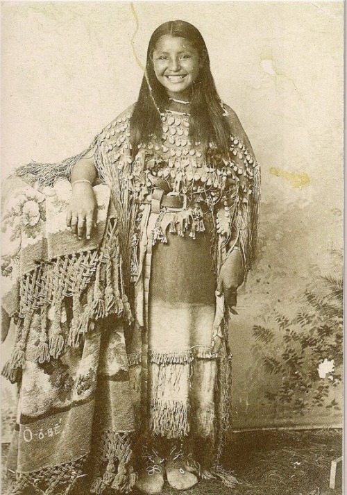 narcolepsy-weed:“O-o-be (Kiowa) wearing a three-hide dress decorated with elk teeth, 1895. For