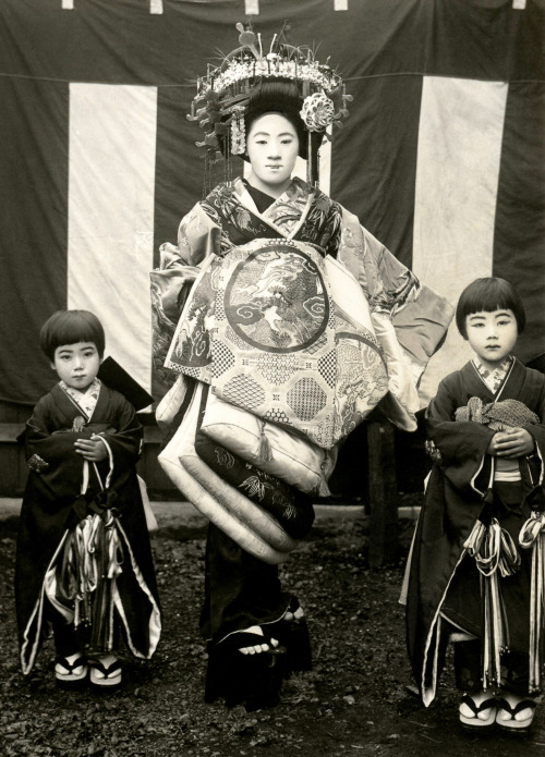 &ldquo;This postcard shows a Tayuu (Japanese Courtesan) and two Kamuro (Child Attendants) standing i